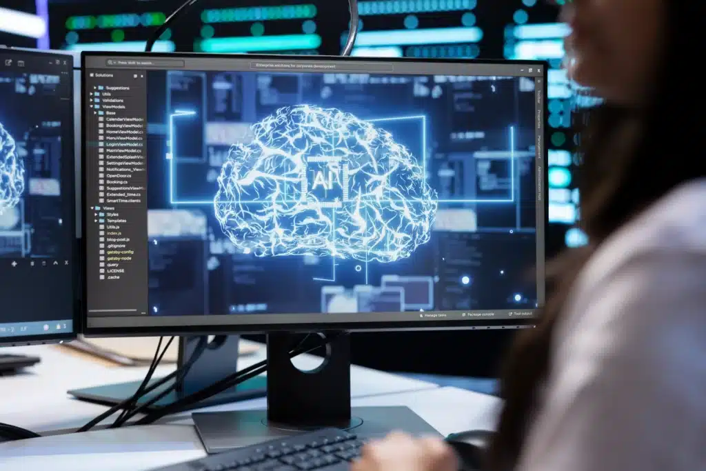 Spécialiste en intelligence artificielle analysant une interface IA sur écran dans un centre de données, représentant le travail dans l’IA technique.